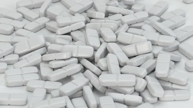 Wei&szlig;e Tabletten - Pillen fallen auf den Boden