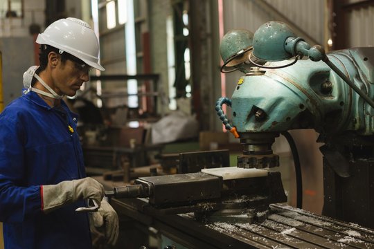 Worker using milling machine