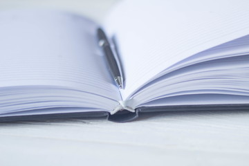 pen and a notebook at the workplace