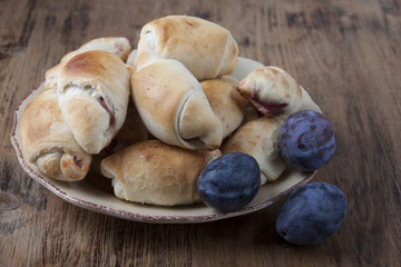 Pies with plums in the form of bagels with plums