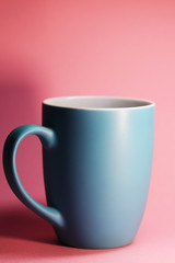 Blue tea cup on pink background food photo