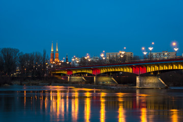 Night view on the Slasko-Dabrowski bridge over the Vistula river, Warsaw, Poland