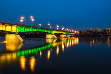 Fototapeta na wymiar Night view on the Slasko-Dabrowski bridge over the Vistula river, Warsaw, Poland