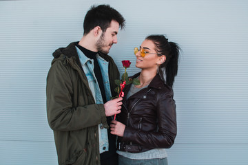 Attractive man gives rose, present to his girlfriend as a Valentines day present.