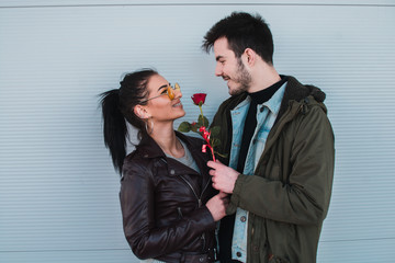 Attractive man gives rose, present to his girlfriend as a Valentines day present.