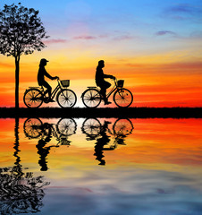 Fototapeta premium Silhouette group bike relaxing on blurry sunrise background