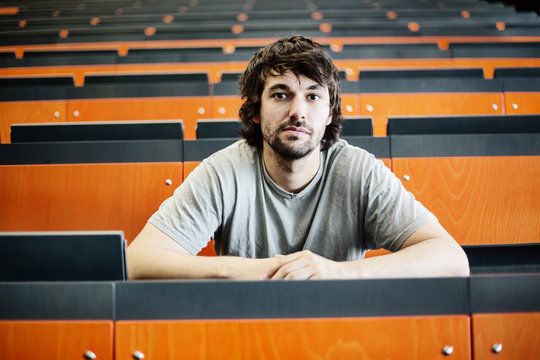 Portrait of student in auditorium at university