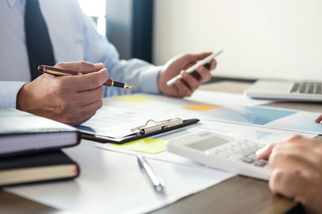 Business team meeting working with new startup project, discussion and analysis data the charts and graphs. Digital tablet calculator, laptop computer using, Business finances and accounting concept