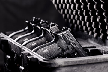 black handgun in plastic Secure Storage Case - obrazy, fototapety, plakaty