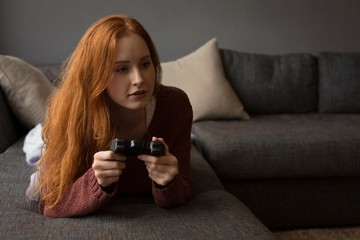 Woman playing video games at home