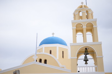 Fototapeta na wymiar Old blue dome church in Santorini. Place for text