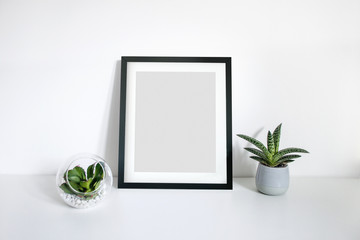 8x10 black portrait frame scene on desk with plants
