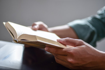 Closeup hand open book for reading concept background