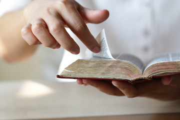 Woman reading holy bible.