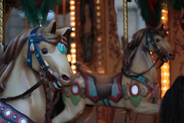 Fototapeta na wymiar Detail of an antique carousel with horses, taken in the center of Florence.