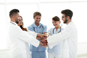 Fototapeta premium Doctors and nurses stacking hands. concept of mutual aid.