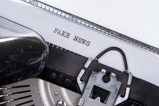 Black text Fake News written on an old typewriter