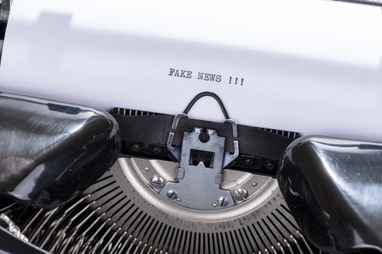 Black text Fake News written on an old typewriter