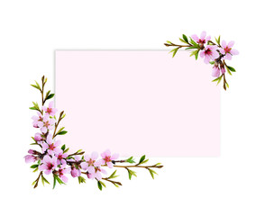 Fototapeta na wymiar Spring twigs of peach flowers and early leaves in corner arrangements with pink card for text
