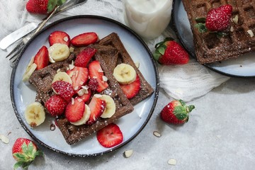 Homemade Chocolate Waffles topped with fresh berries ans banana