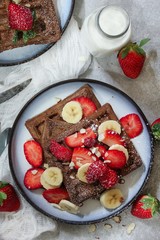 Homemade Chocolate Waffles topped with fresh berries ans banana