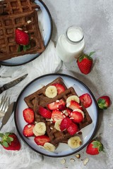 Homemade Chocolate Waffles topped with fresh berries ans banana