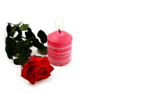 Red rose with candle stock images. Pink candle with red roses. Romantic roses on a white background. Valentines Day concept