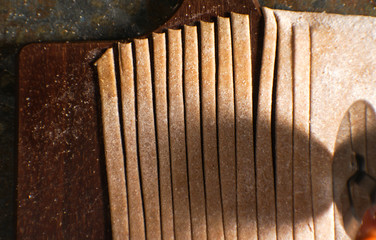 Knife cut the dough for pasta on smooth strips