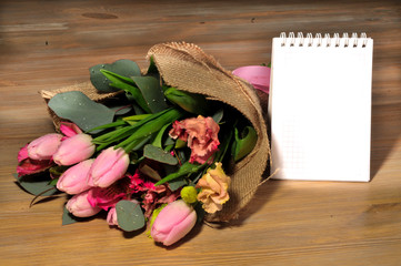 bouquet of tulips on the table with a note