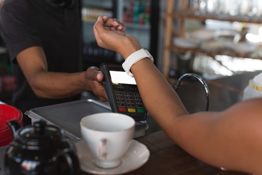 Teenage girl making payment through smartwatch