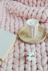 Cup with cappuccino, pink pastel giant plaid, fur, bedroom, morning concept