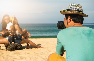 Photographers are photographing a lesbian couple in the honeymoon with blur beach background On the beach in Thailand in travel and holiday concept .