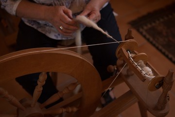 Senior woman weaving silk at shop