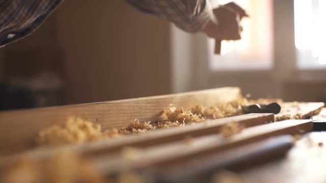 carpenter planed wood, workplace. Slow motion