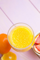 Fruit and Vegetable Smoothie, Healthy Food, Diet Concept. A glass of fresh citrus smoothie on pink wooden background, top view