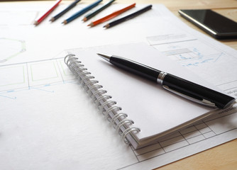 Notebook with copy space in the hands on the background of an architectural project.
