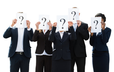 Businesspeople Hiding Face Behind Question Mark Sign