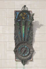 Artistic wall clock on the main square of Lecce, Italy