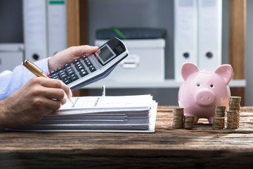 Businessperson's Hand Calculating Bill
