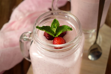 Protein cocktail with strawberries and mint in a glass jar
