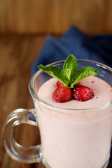 Protein cocktail with strawberries and mint in an Irish mug on wooden background