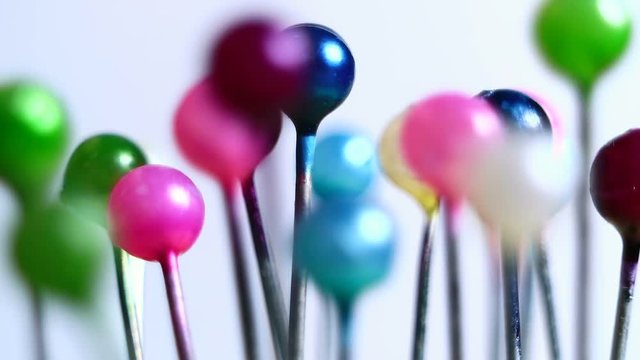 Tools tailor. Many multi-colored pins close-up. Shallow depth of field. Smooth rotation and impact.