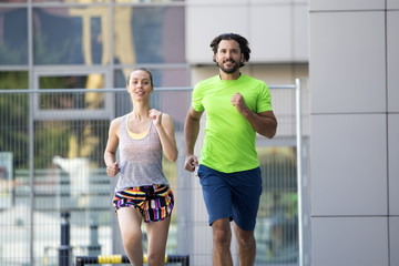 Fototapeta na wymiar Couple running in urban enviroment
