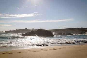 beautiful beach with waves breaking on the shore and without people
