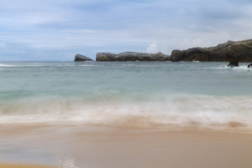 beautiful beach with waves breaking on the shore and without people
