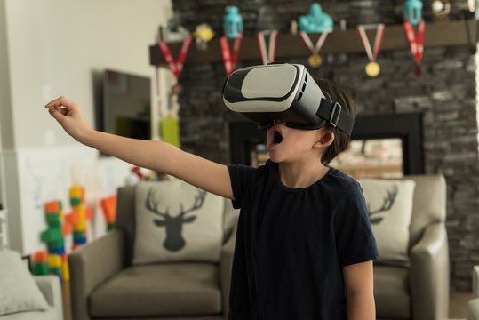 Boy using virtual reality headset in living room