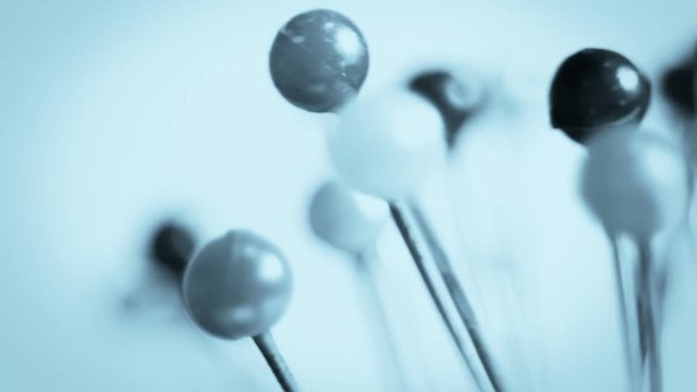 Tools tailor. Many multi-colored pins close-up. Shallow depth of field. Smooth rotation and impact.