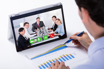 Businessman Video Conferencing On Hybrid Laptop