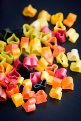 Heart-shaped pasta on black wood table