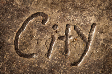 word city carved into cement in an alleyway down town 